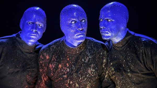 Members of the Blue Man Group, covered in paint after a drum session.